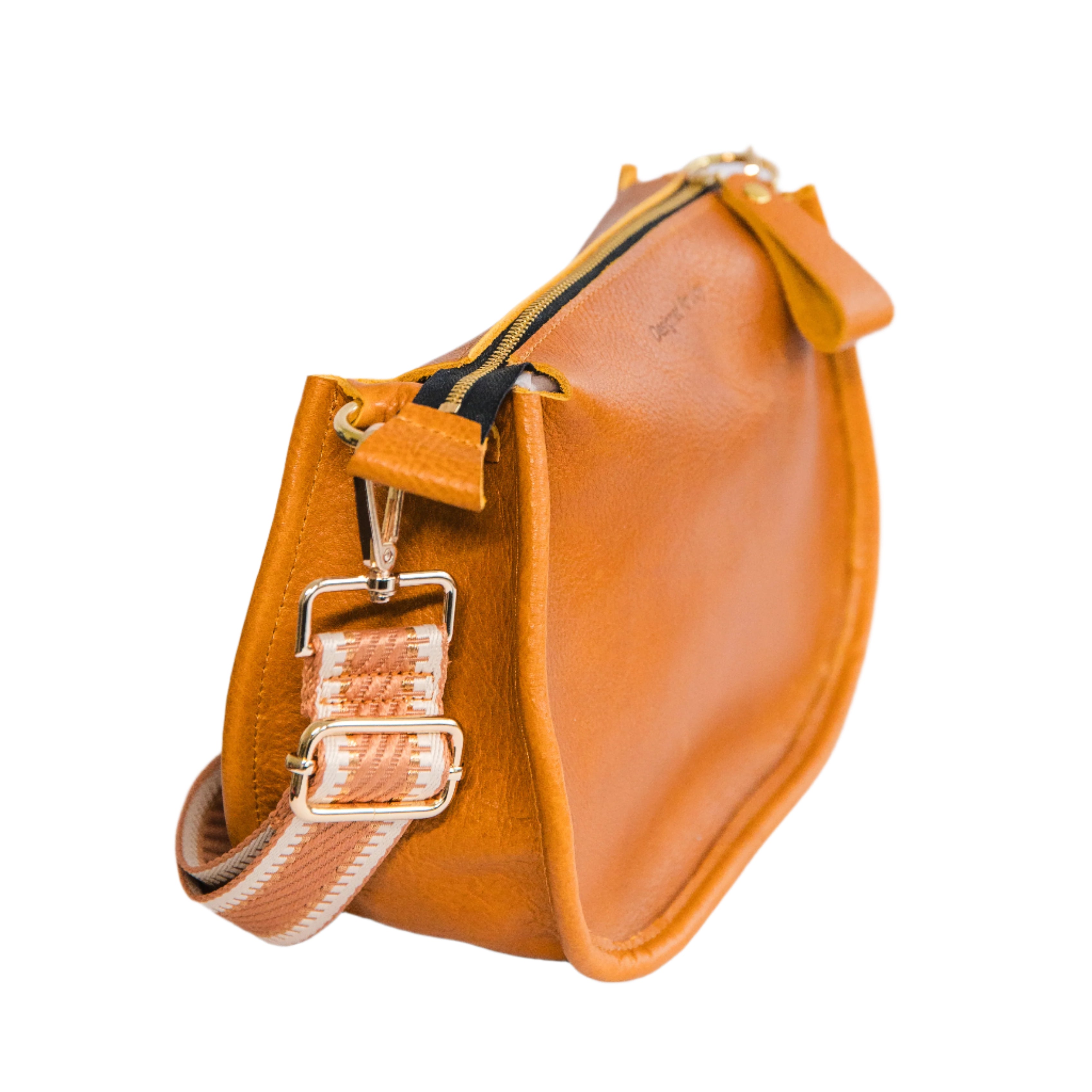 Side view of a caramel brown crossbody handbag