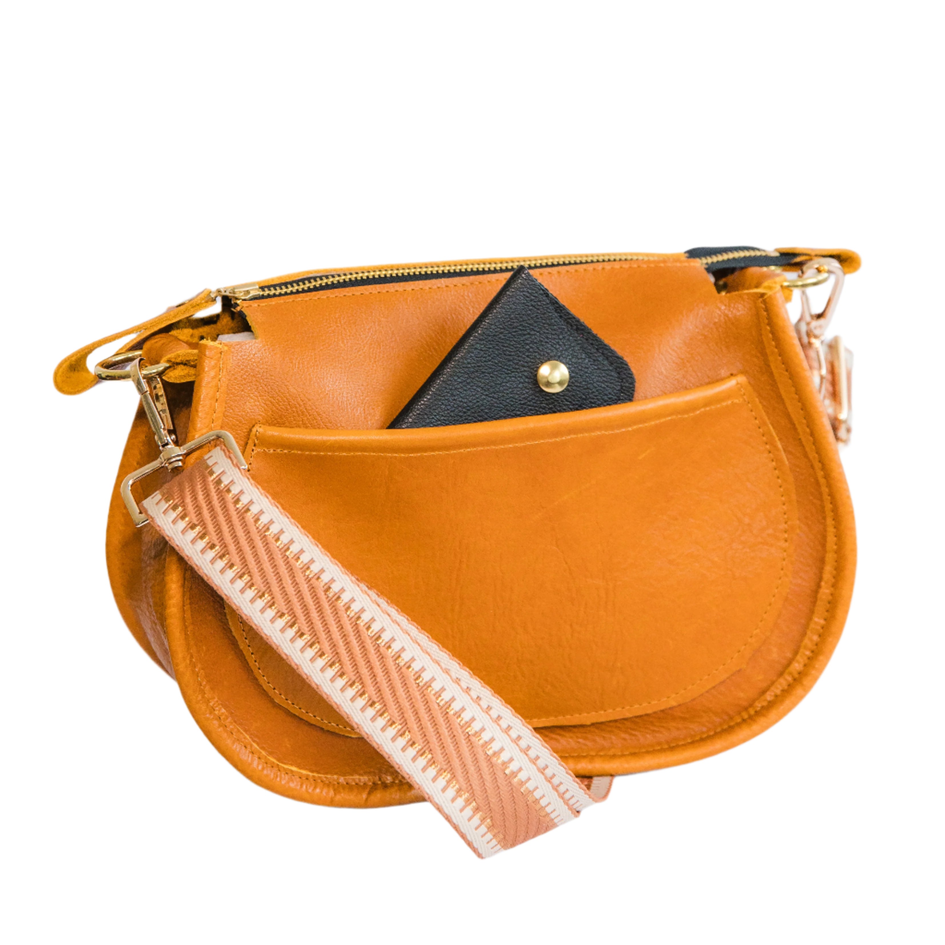 Back of a caramel brown crossbody handbag with a wallet peeking out of the back pocket