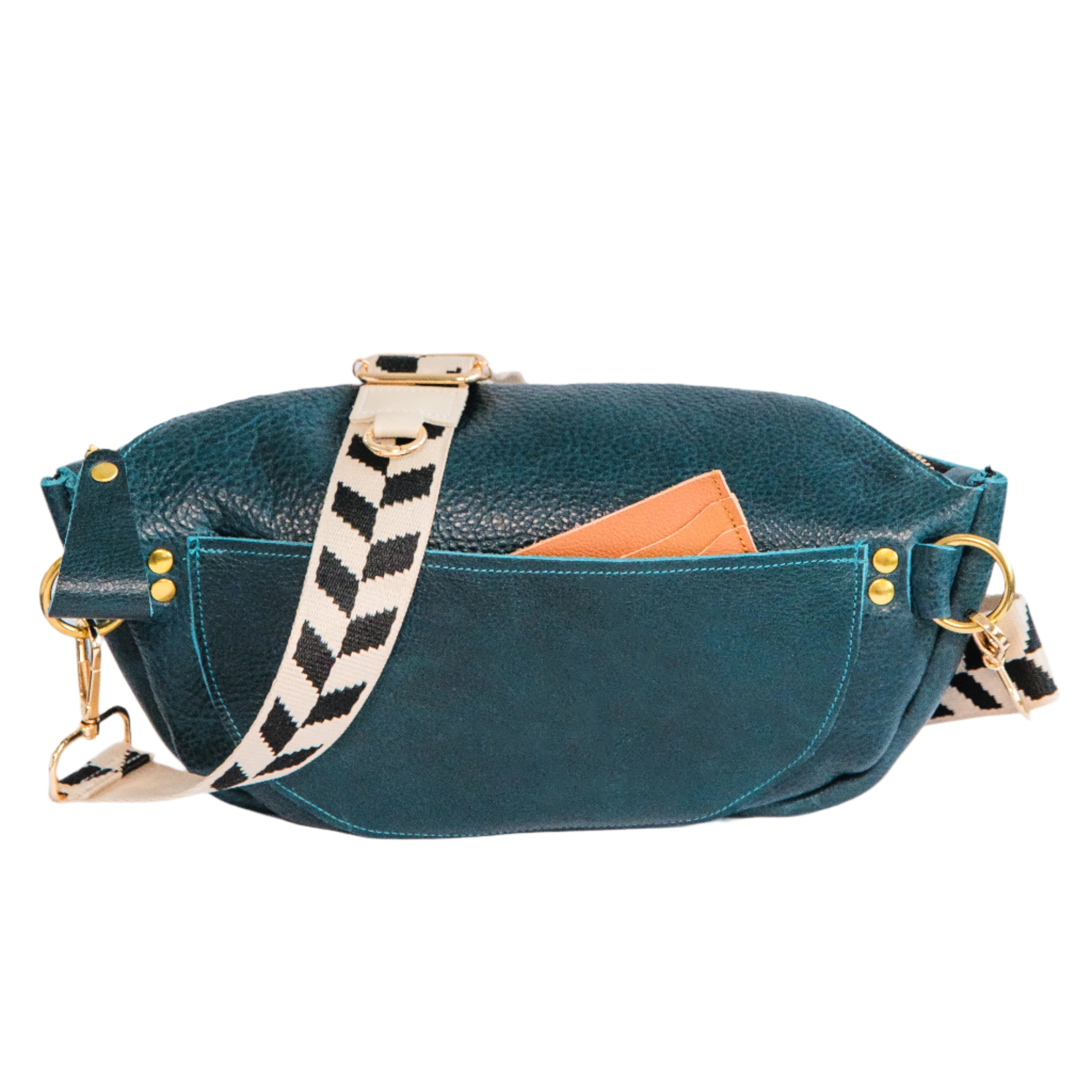 Back of teal crossbody sling handbag with a wallet peeking out of the pocket, on a white background