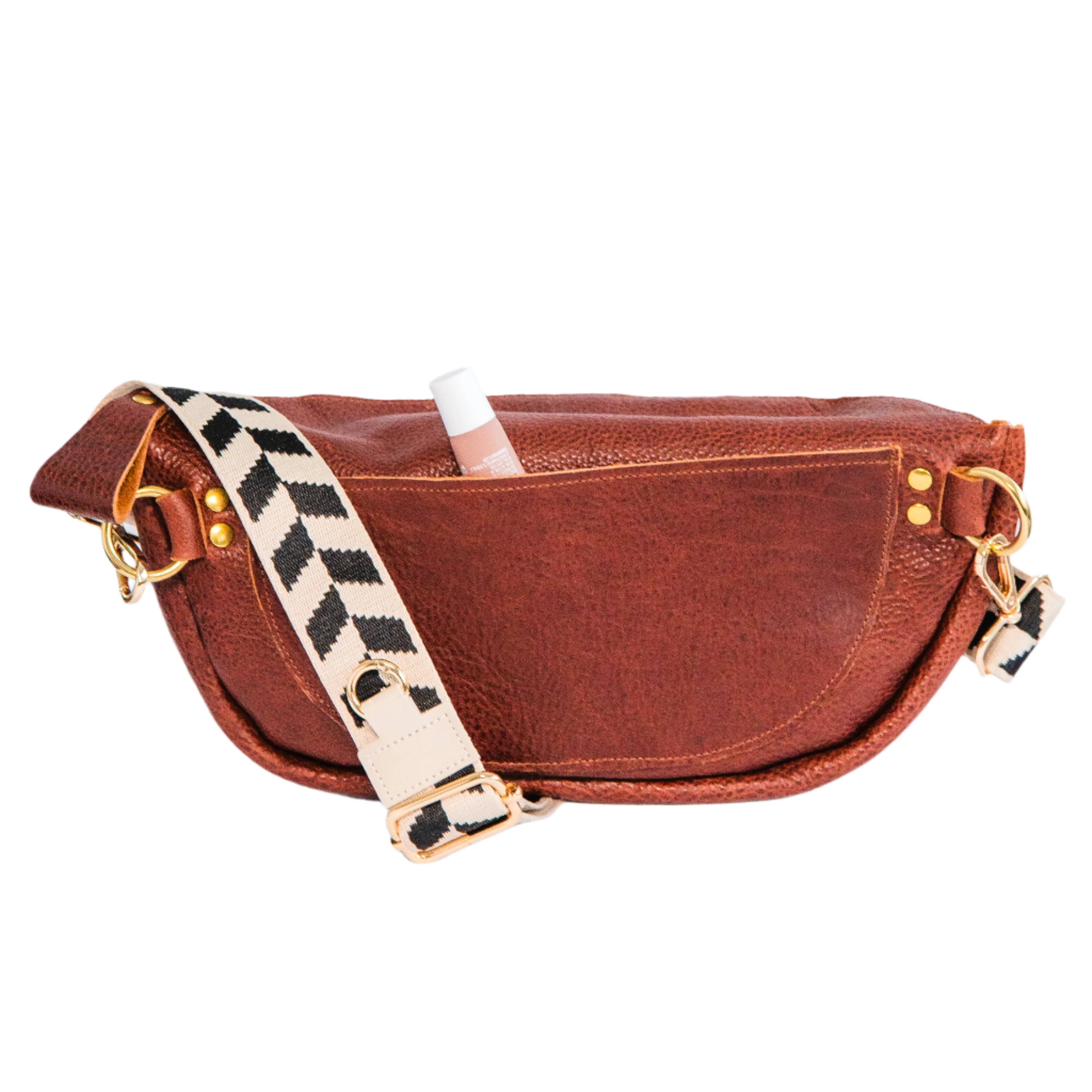 Back of cinnamon brown crossbody sling handbag with a lip balm peeking out of the pocket, on a white background