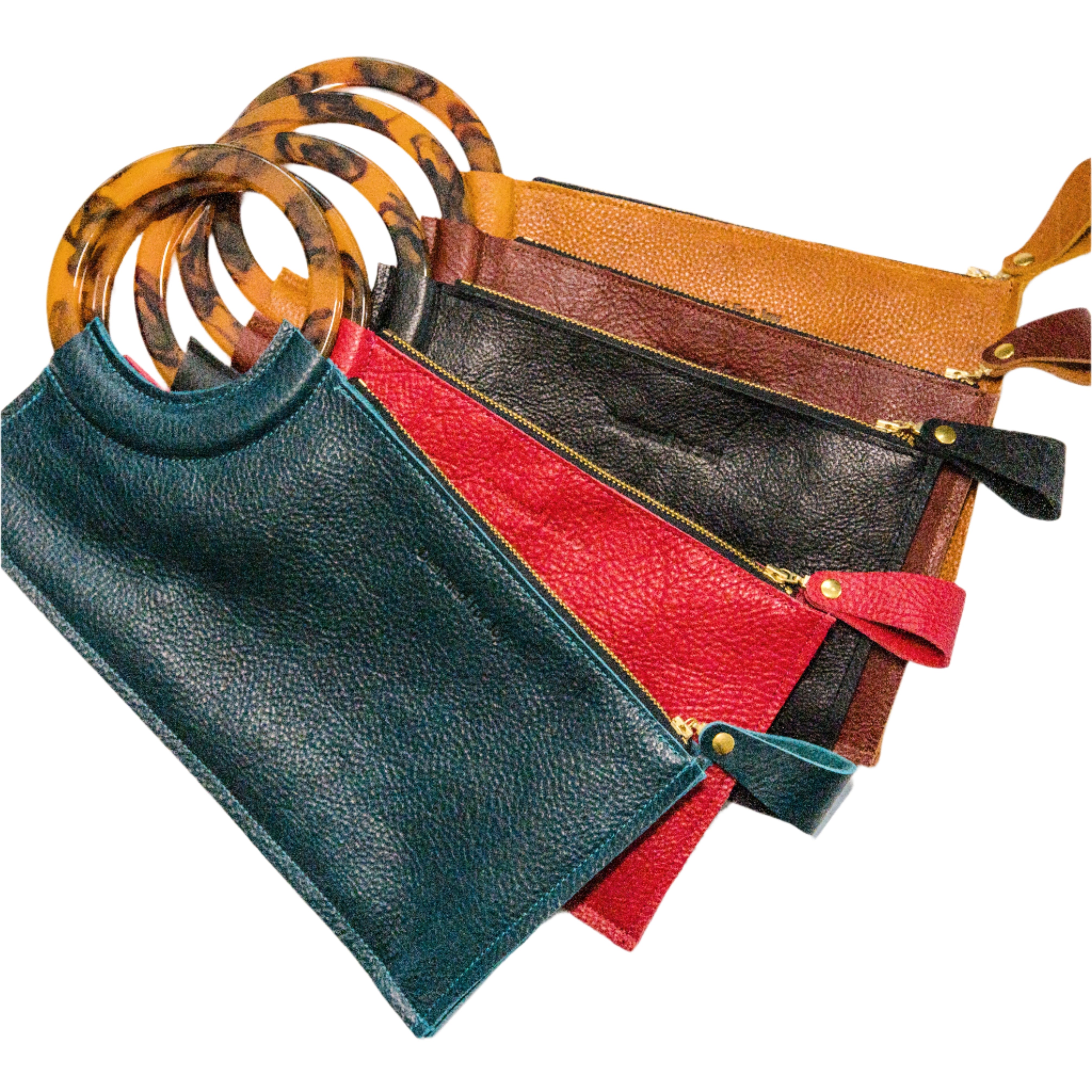 Collection of wristlet handbags in various colors including teal, red, black, cinnamon brown, and caramel brown, with smooth resin handles and chunky zipper closures, on a white background