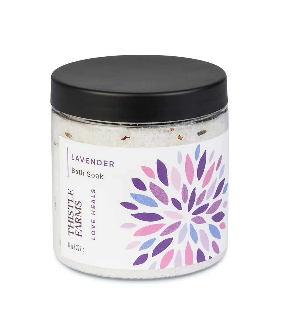 Thistle Farms lavender bath soak with a floral design, displayed on a white background