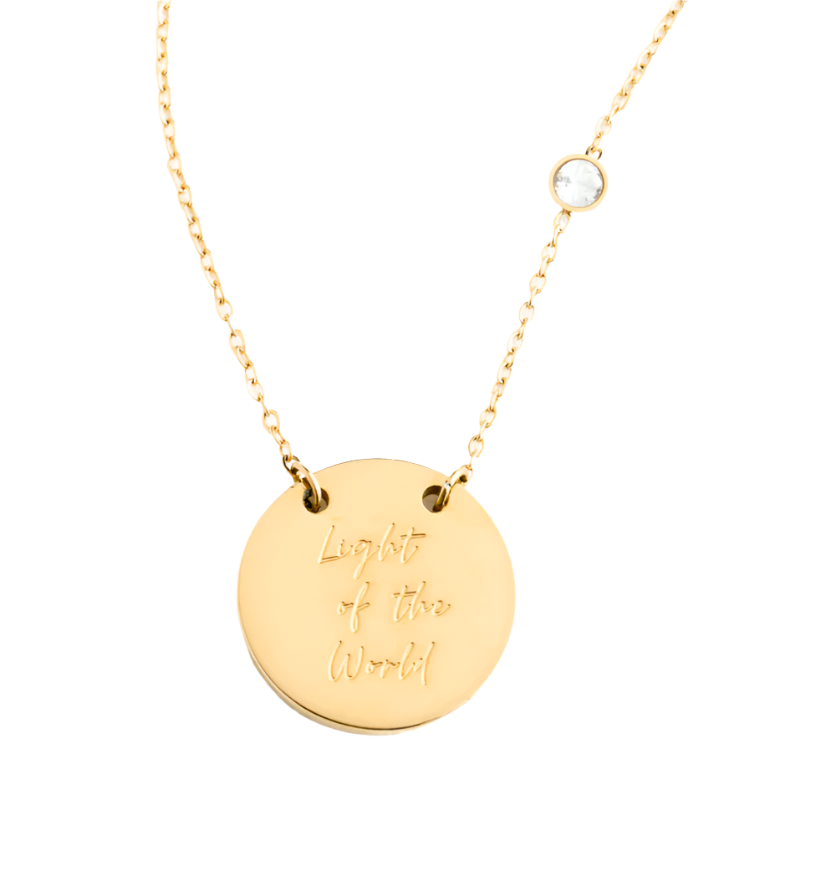 A gold-colored necklace with a circular pendant with 'Light of the World' text, displayed on a white background