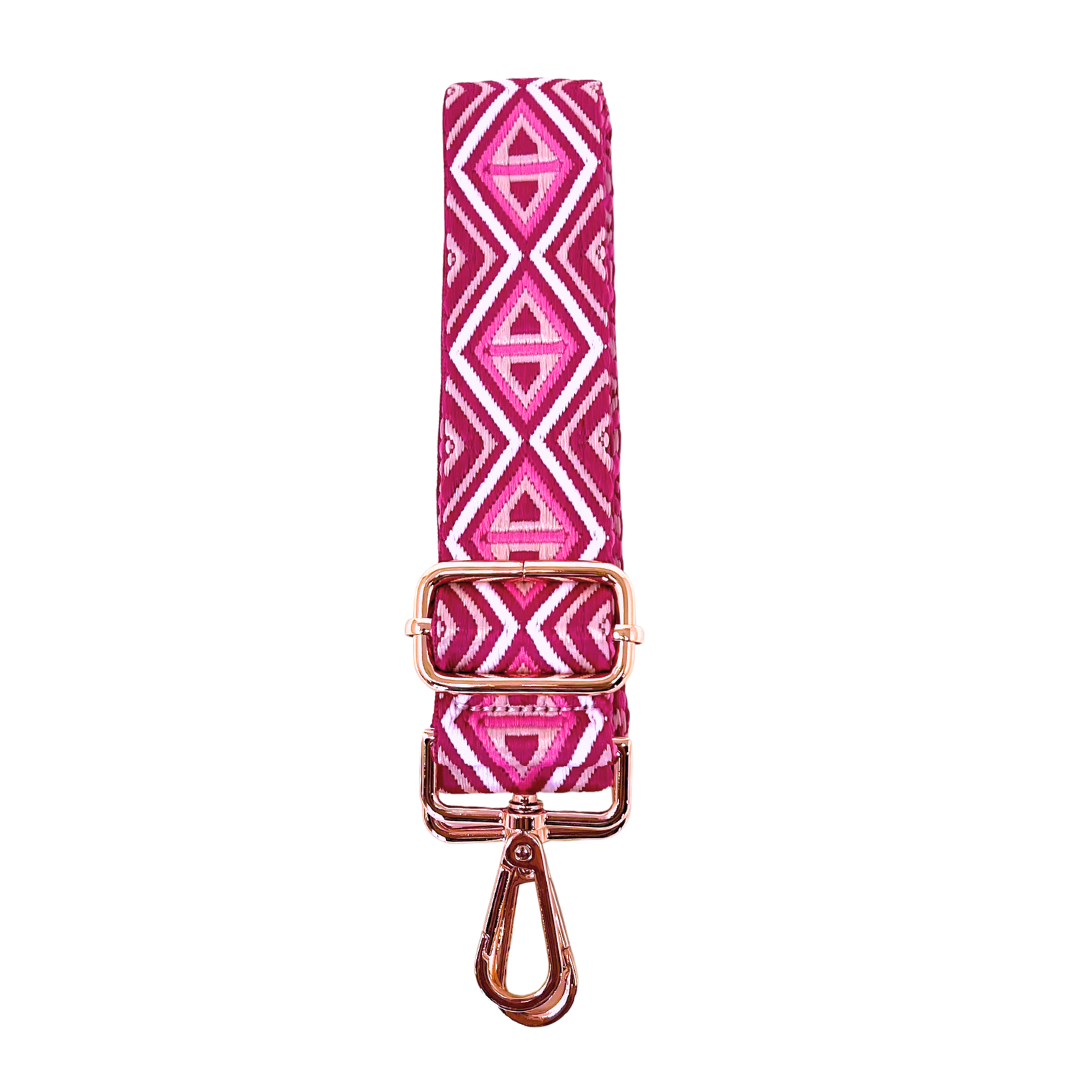 Pink diamond patterned crossbody strap with rose gold hardware on a white background