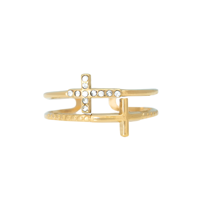 Gold-colored stainless steel ring with a double band design and a small cross with clear stones embedded into it, displayed on a white background
