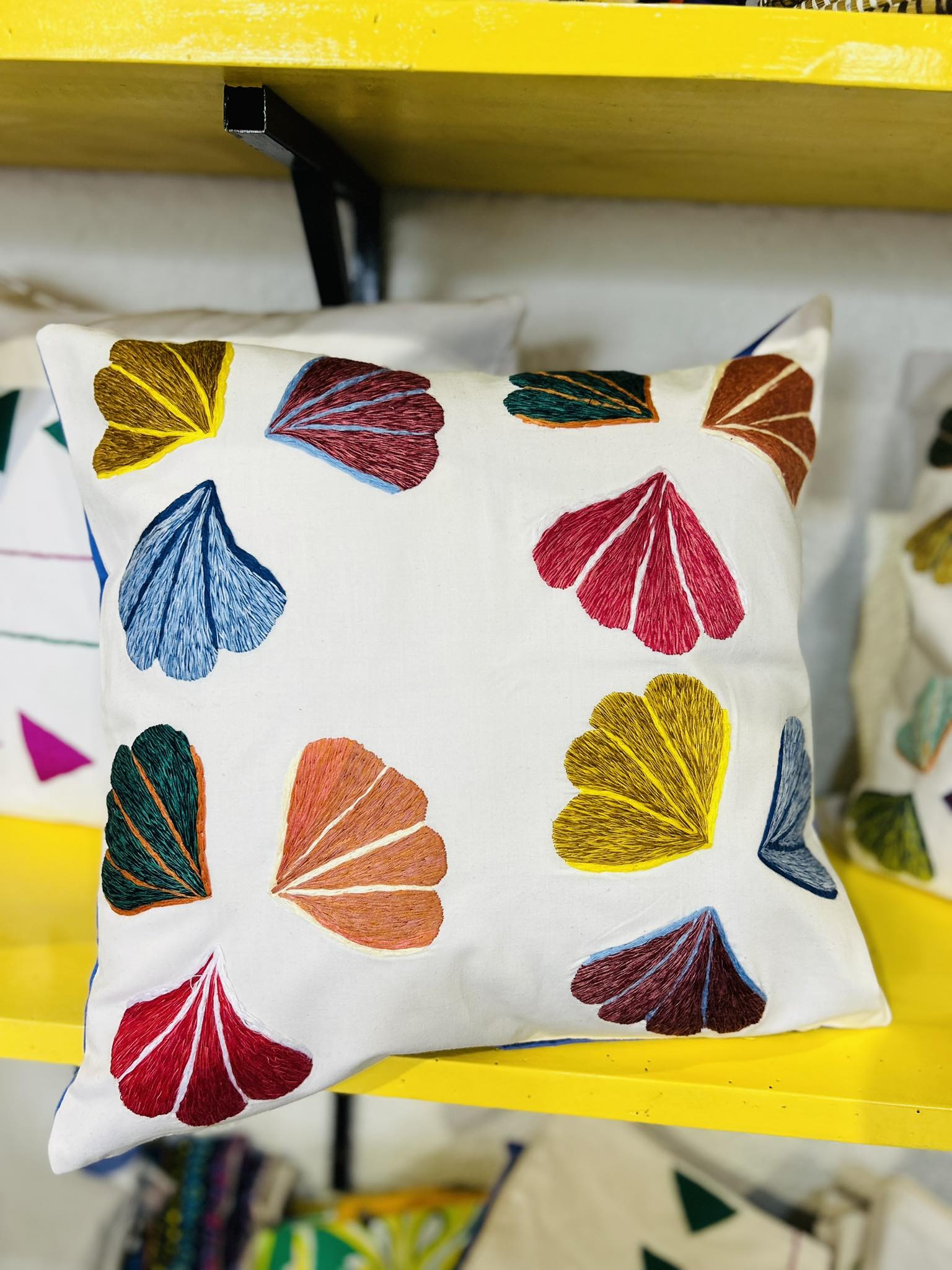 Decorative white pillow with multi-colored gingko leaves