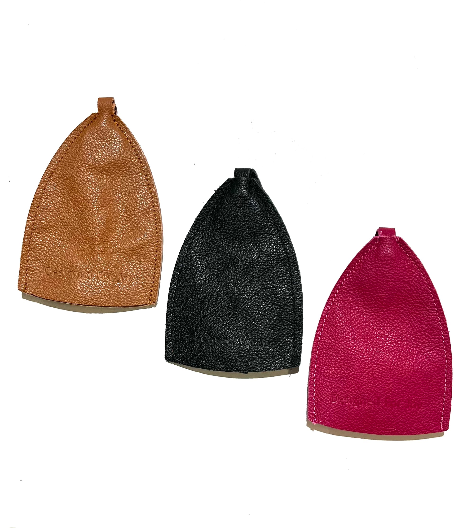 Three leather car key covers in brown, black, and pink colors, on a white background