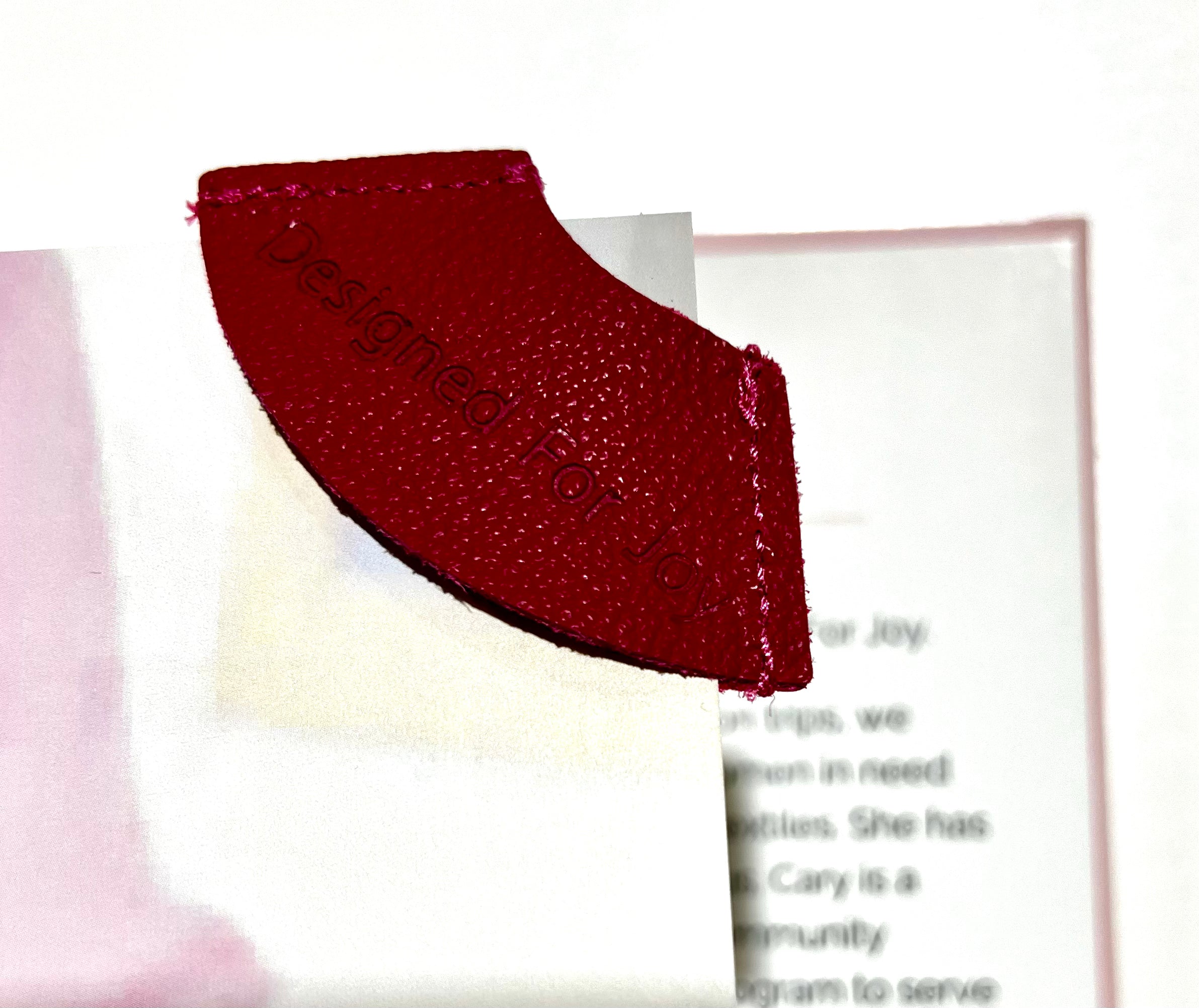 Pink leather bookmark on top a blurred background