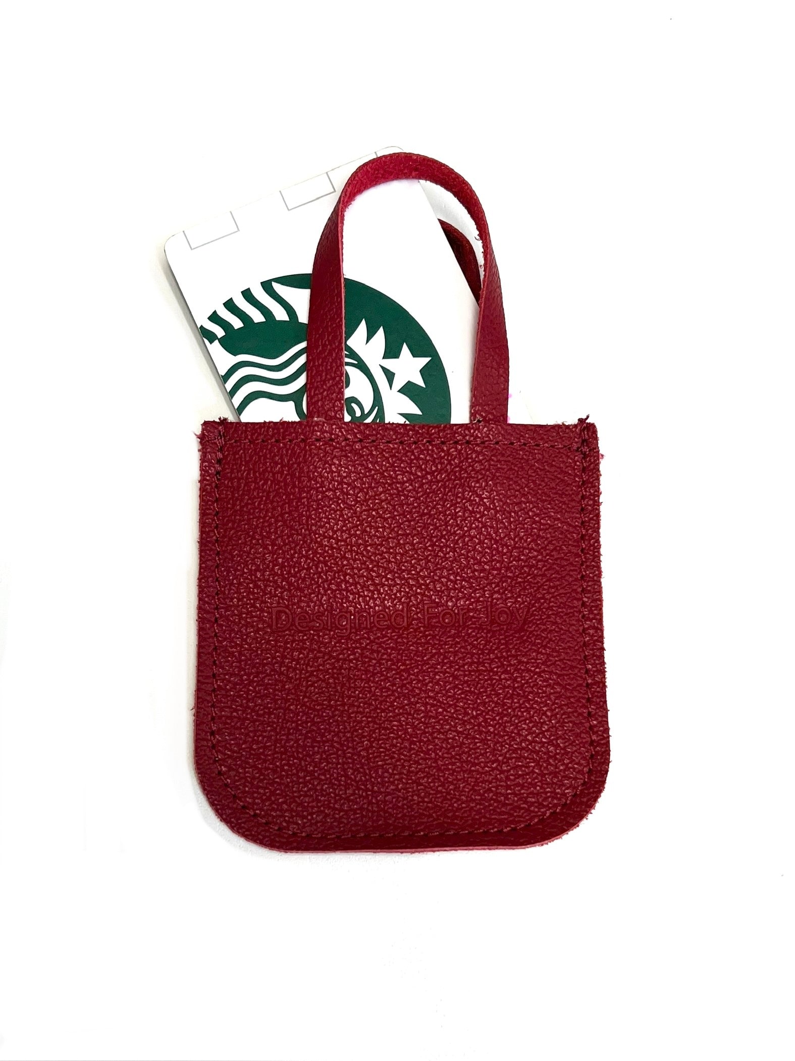 Red leather mini tote bag with a gift card holder inside, displayed on a white background