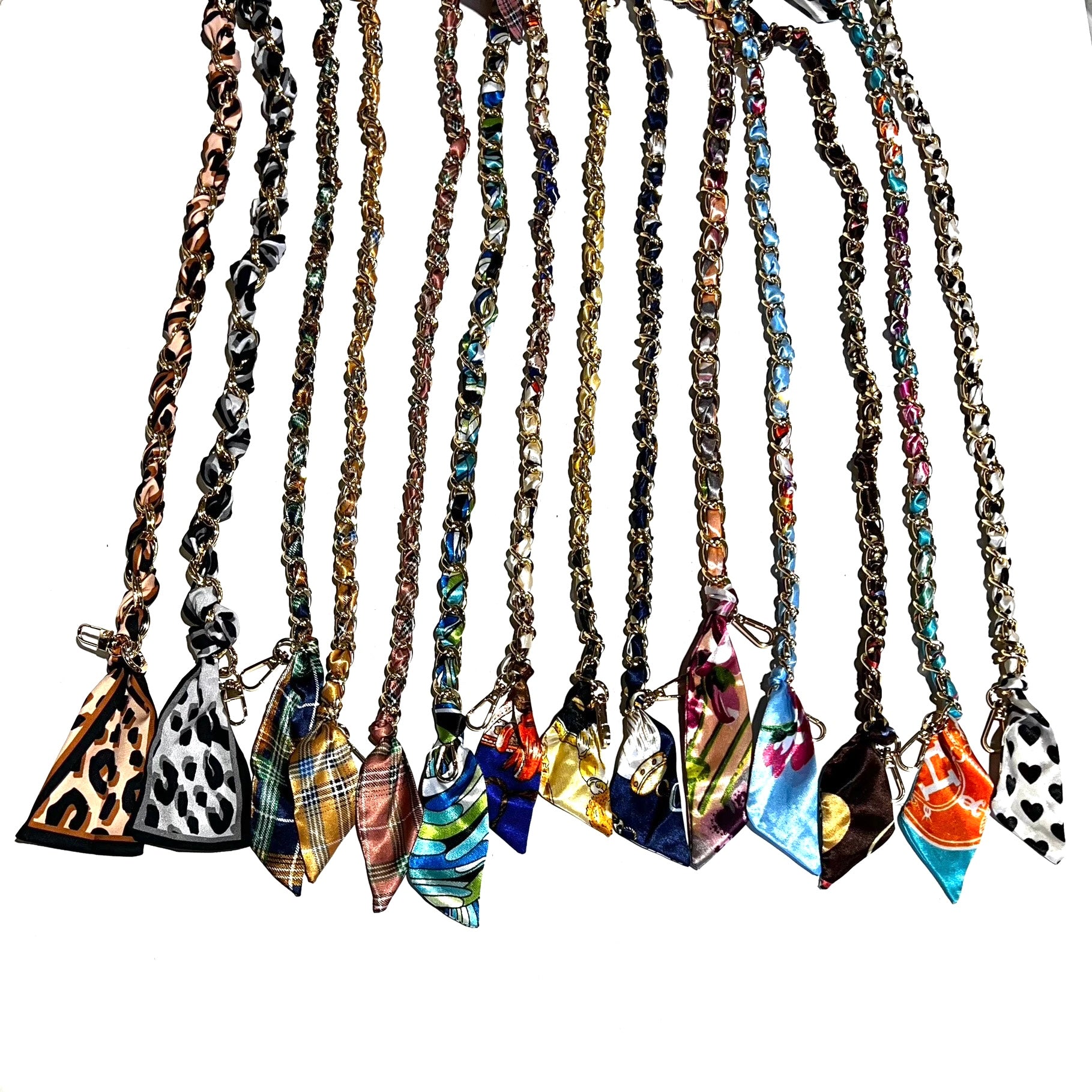 A collection of colorful scarf chain straps with various patterns, including floral, striped, and animal prints, displayed in a row