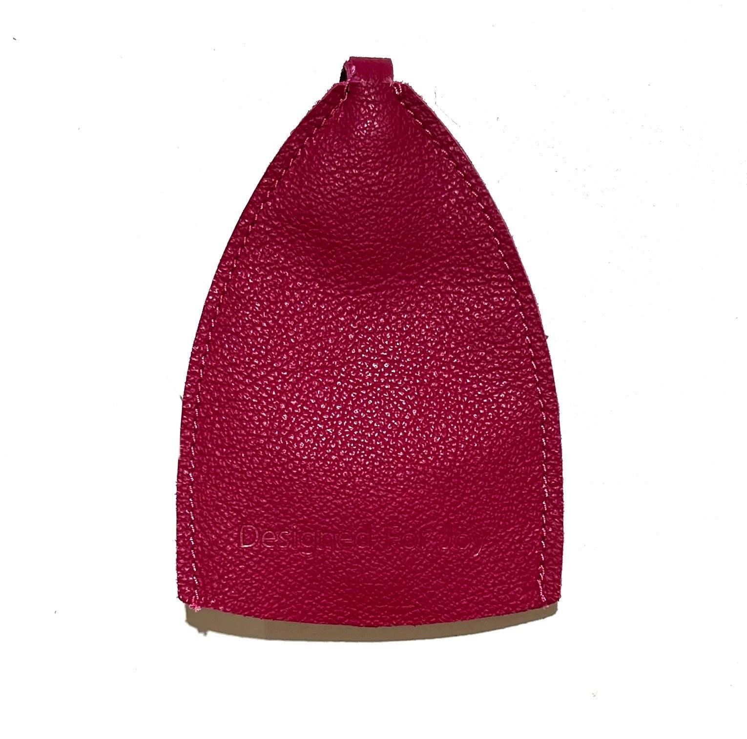 Pink leather car key cover with 'Designed for Joy' text on a white background