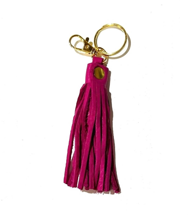 Pink leather tassel keychain, displayed on a white background