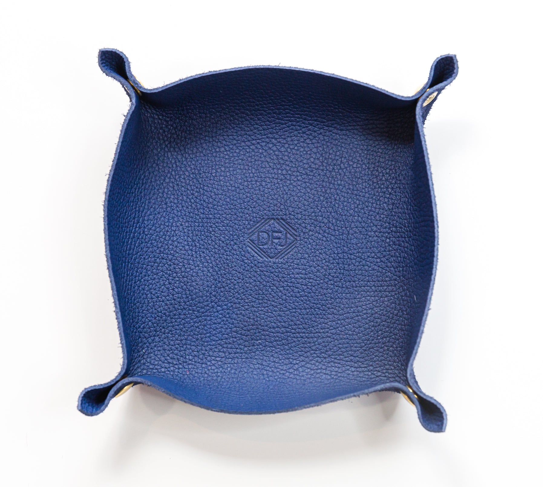 Navy blue valet tray with pinched corners and brass snaps, displayed on a white background