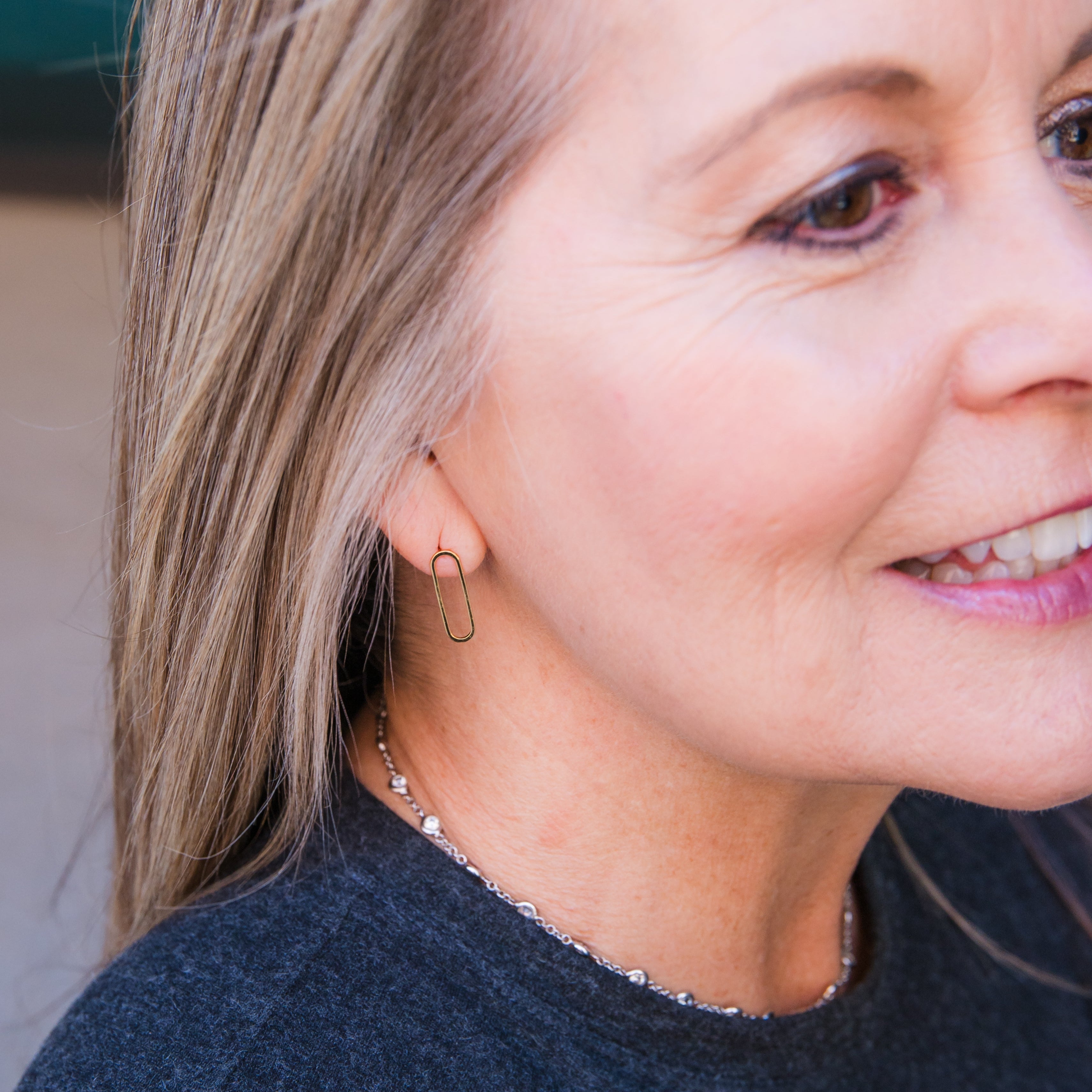 Close-up of a person wearing a paperclip post earring