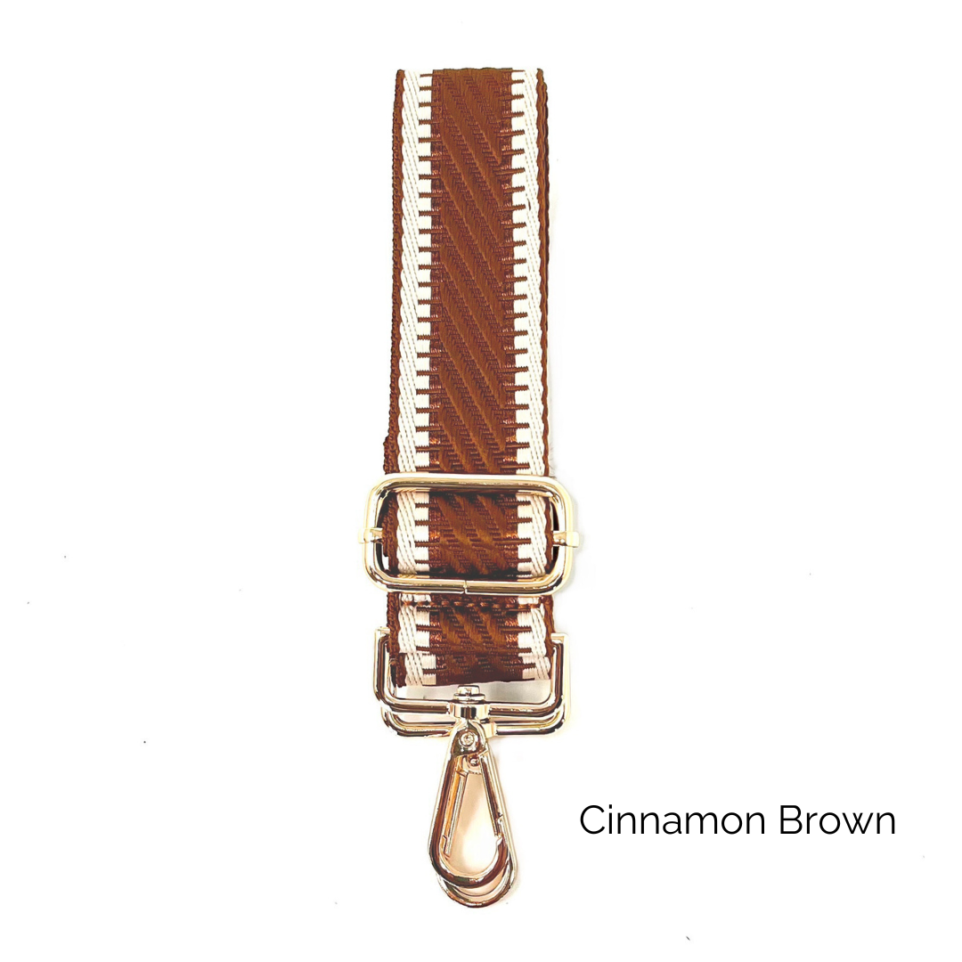 Cinnamon brown crossbody strap with metallic thread details and gold hardware on a white background