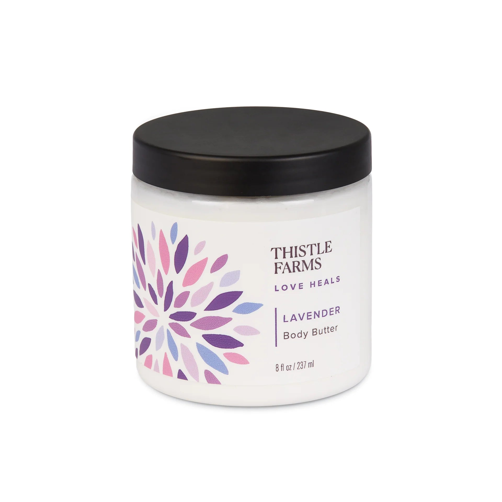 White jar with a black lid containing 'Thistle Farms Lavender Body Butter' featuring a colorful geometric design, displayed on a white background