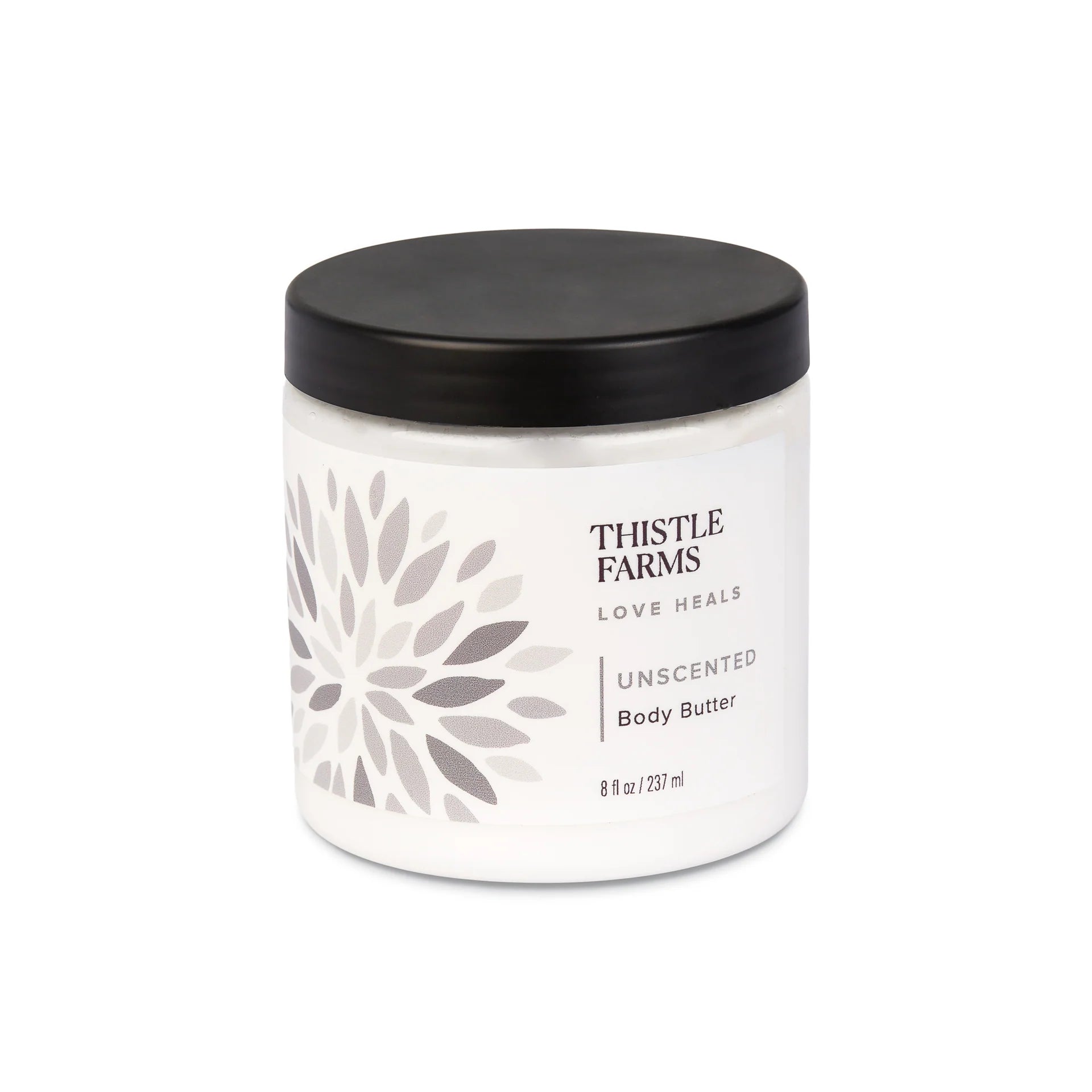 White jar with a black lid containing 'Thistle Farms Unscented Body Butter' featuring a gray geometric design, displayed on a white background