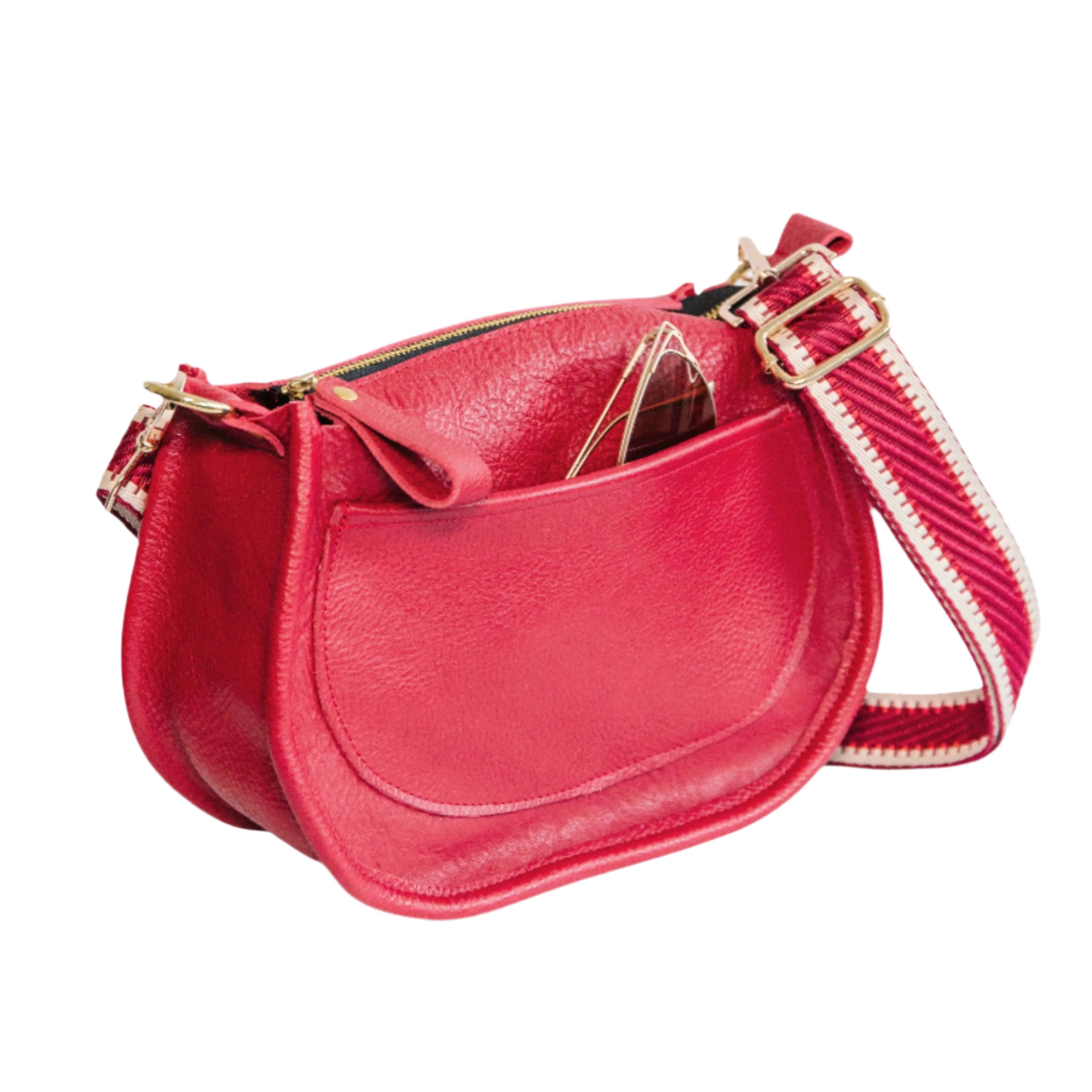 Back of a red crossbody handbag with sunglasses peeking out of the back pocket