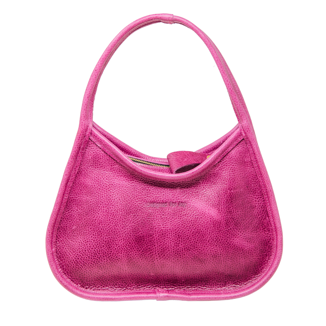 Pink leather shoulder handbag with a wide base and narrow handles displayed on a white background