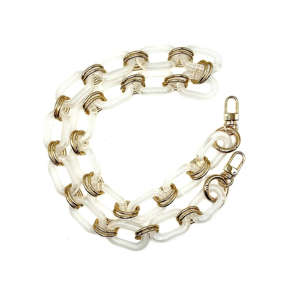 White acrylic chain crossbody handbag strap with gold accents and clips