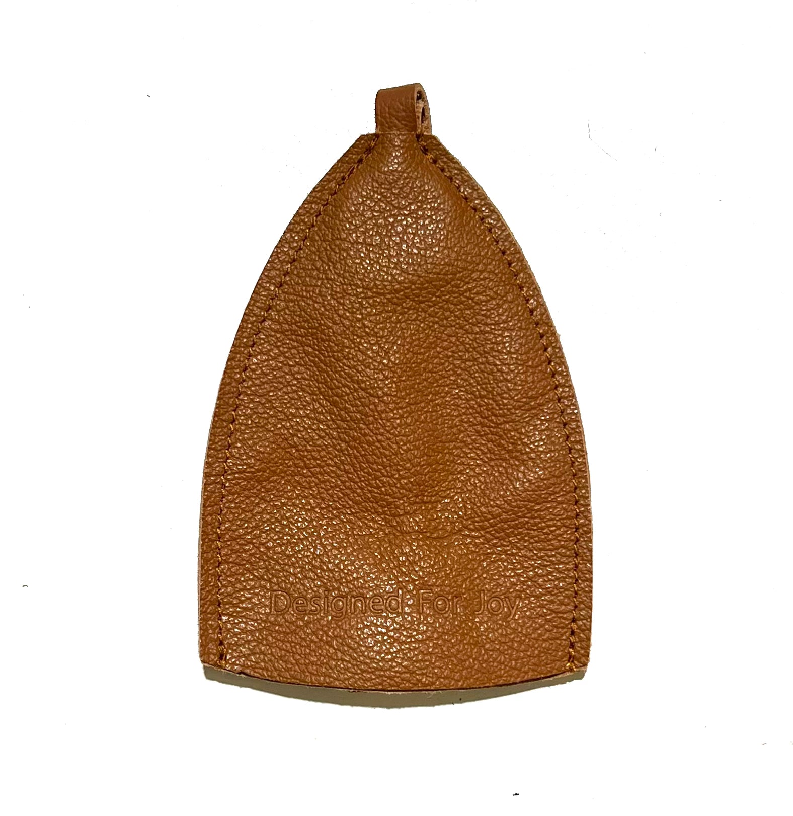 Caramel brown leather car key cover with 'Designed for Joy' text on a white background
