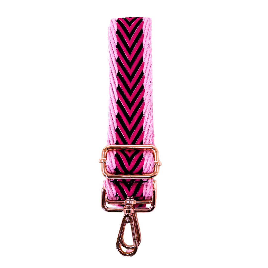 Pink and black chevron patterned crossbody strap with rose gold hardware on a white background