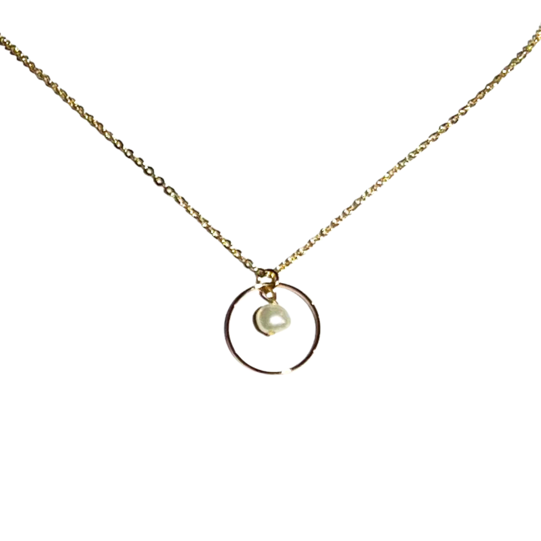 Gold necklace with a circular pendant featuring a pearl, displayed on a white background