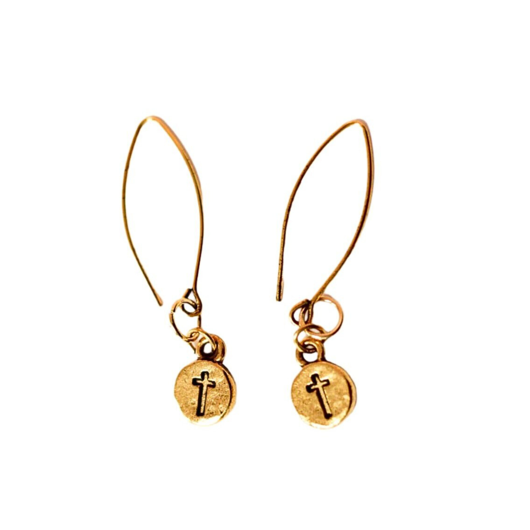 Pair of gold-colored cross charm earrings with long ear wires, displayed on a white background