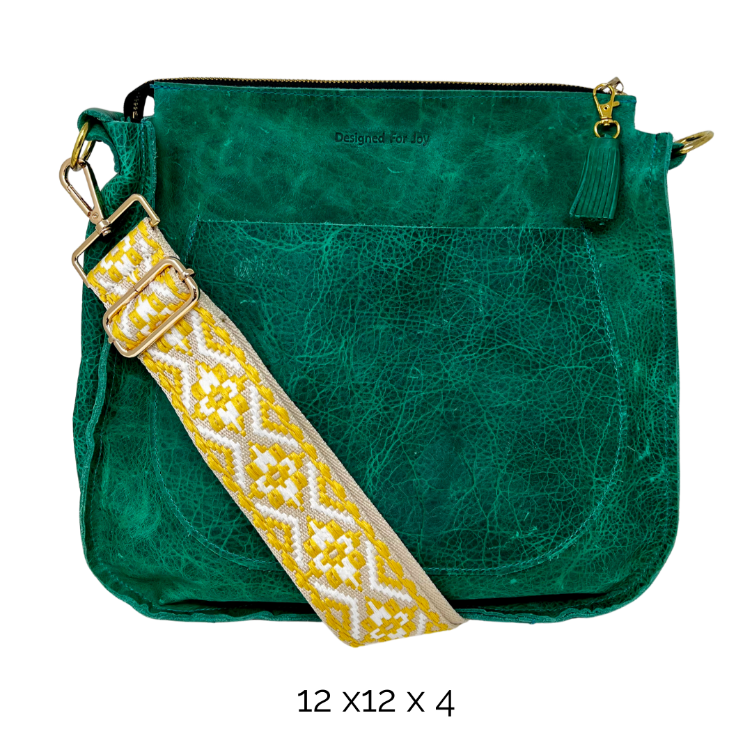 Green leather bag with a yellow tapestry strap on a white background