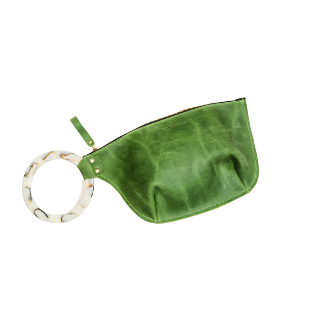 Green wristlet handbag with a smooth resin handle and a zippered compartment, displayed on a white background