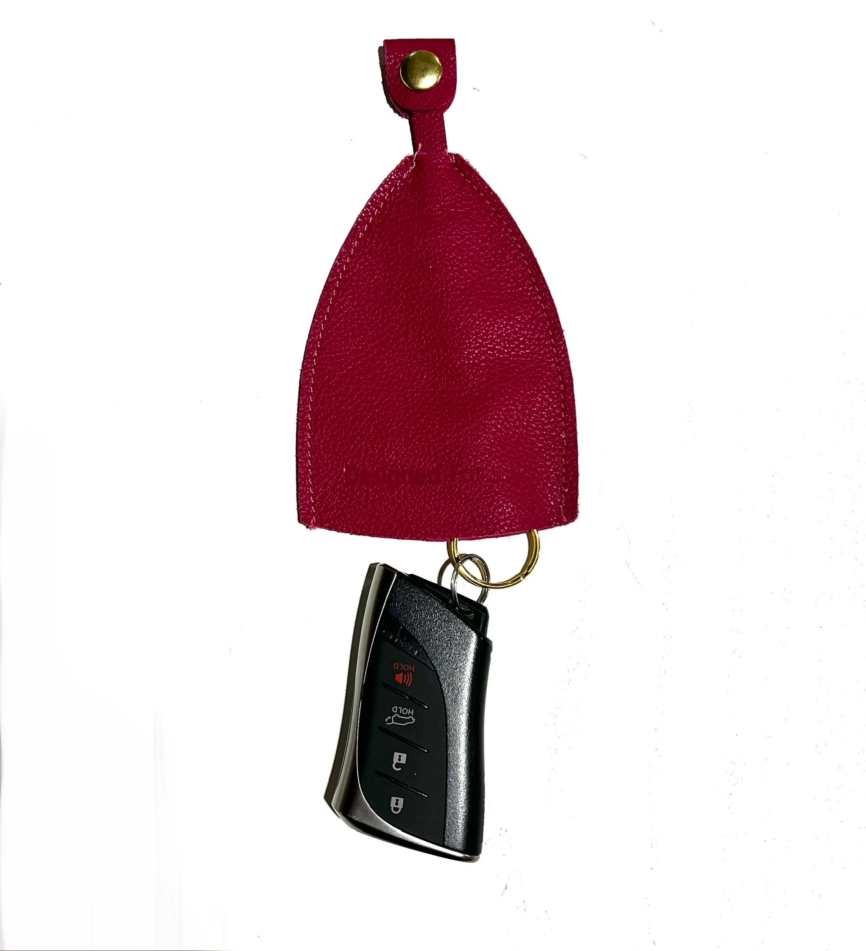 Pink car key cover with a car key displayed below it on a white background