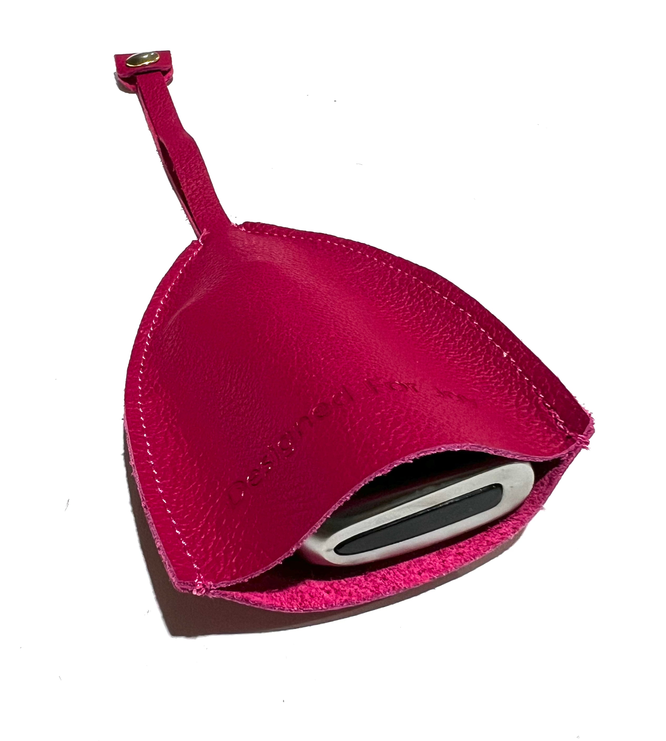 Pink car key cover lying on a white background with a car key inside of it