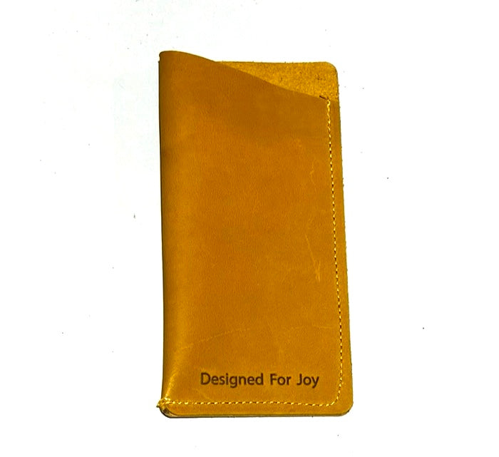 Butterscotch brown slim eyeglass case with a suede interior and angled top design, displayed on a white background