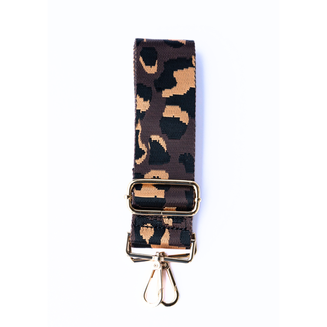 Brown, tan, and black adjustable crossbody strap with a leopard pattern and metal hardware, displayed on a white background