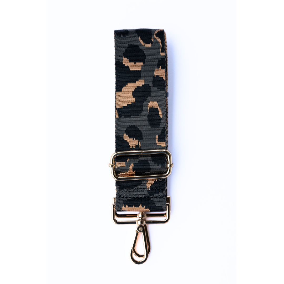Gray, tan, and black adjustable crossbody strap with a leopard pattern and metal hardware, displayed on a white background