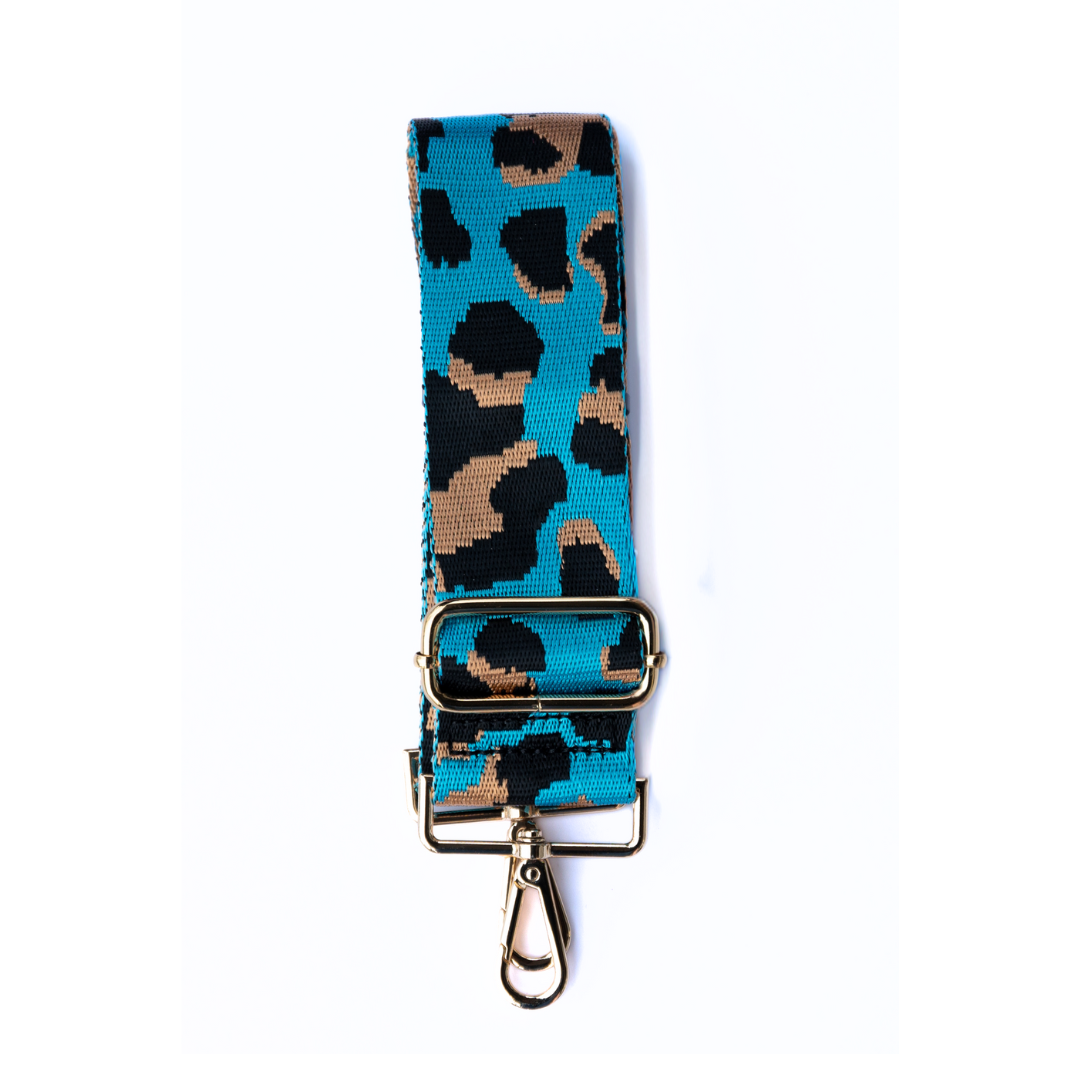 Turquoise, tan, and black adjustable crossbody strap with a leopard pattern and metal hardware, displayed on a white background