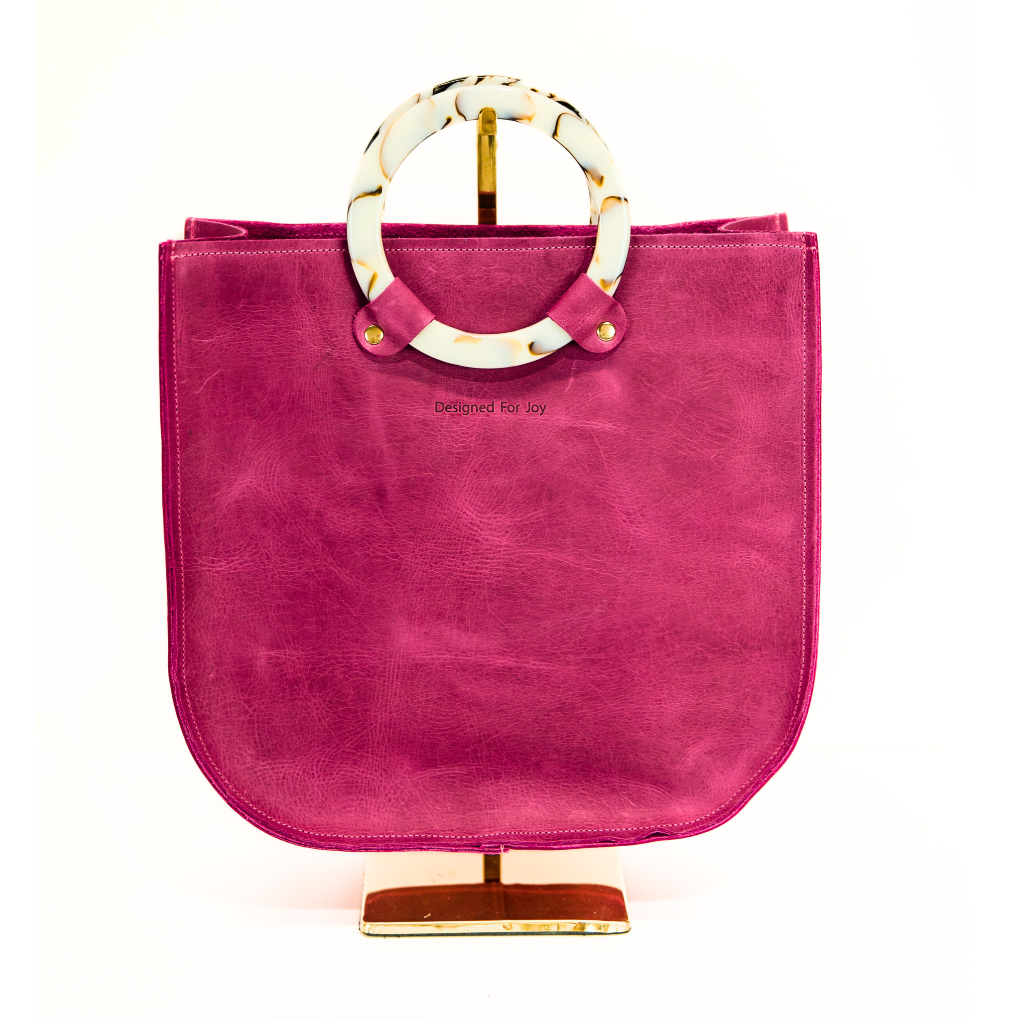 Raspberry pink top handle tote bag with smooth resin handles, displayed on a white background