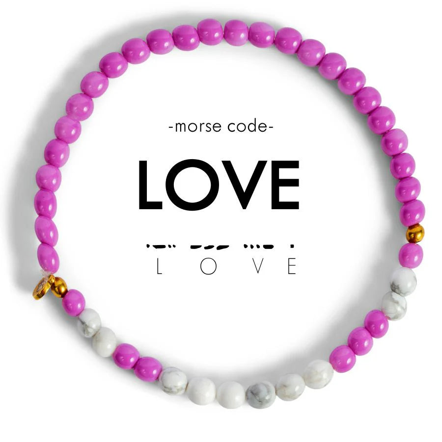Purple and white beaded bracelet with the word 'LOVE' in Morse code and a small gold heart charm
