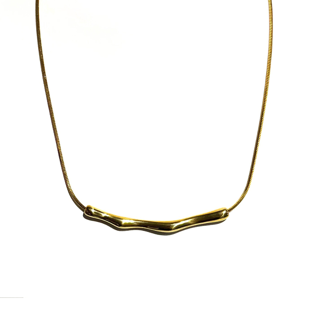 Gold-plated wavy bar necklace on a serpentine chain, displayed on a white background