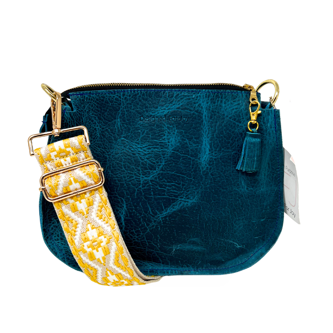 Blue bag with a yellow tapestry strap on a white background