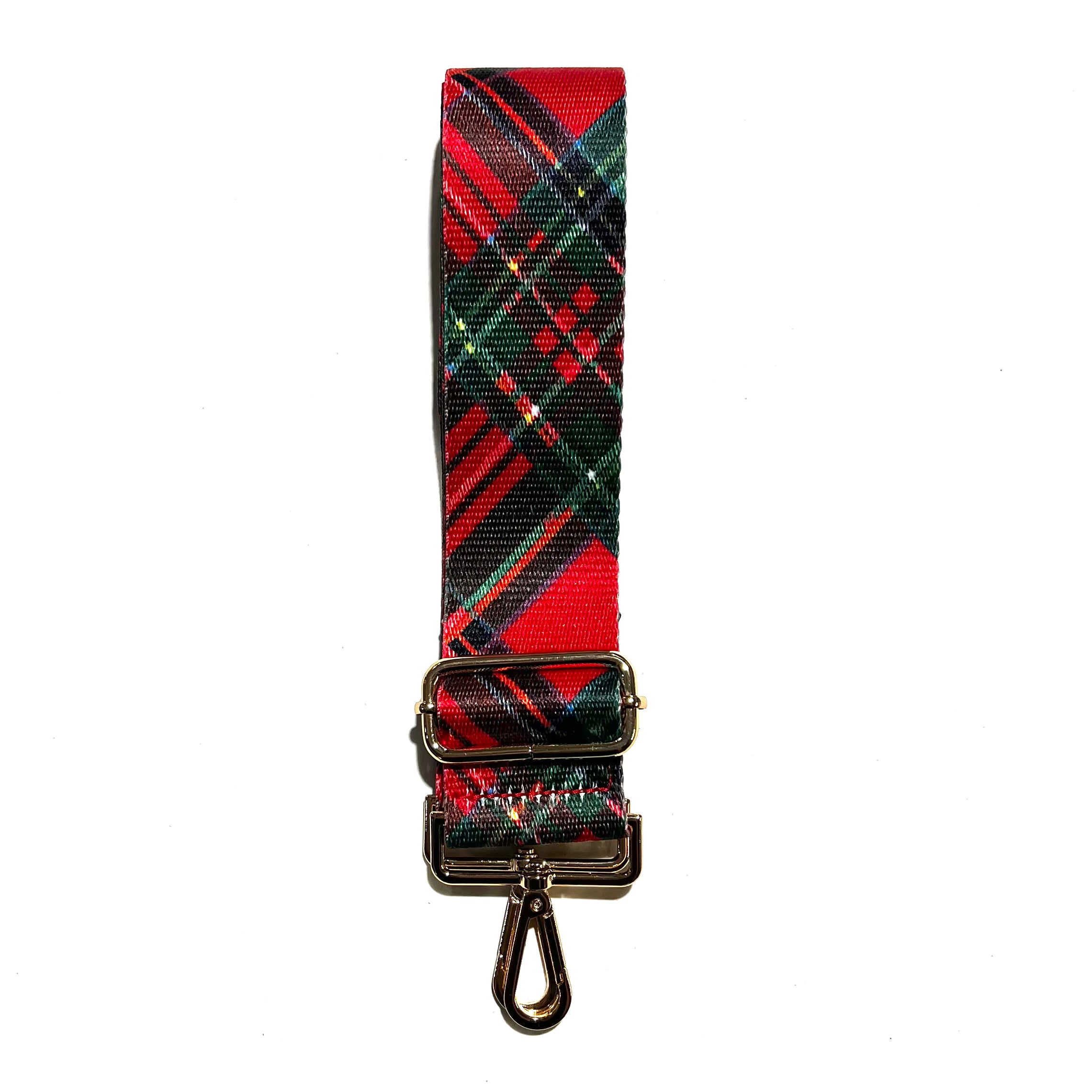 Red adjustable crossbody strap with a plaid pattern and metal hardware, displayed on a white background