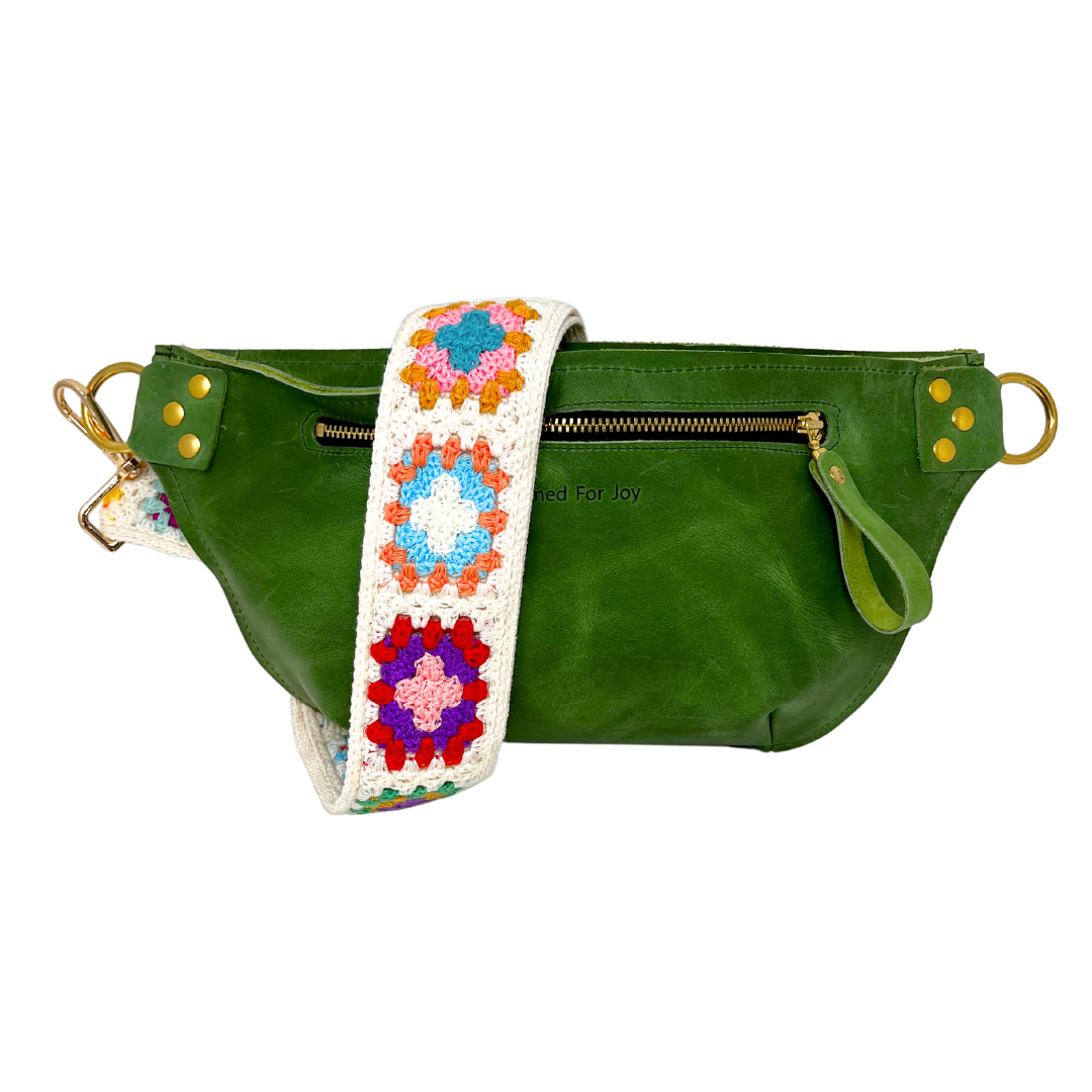 Evergreen leather crossbody sling bag with a multicolored crochet square strap, featuring a full zippered compartment