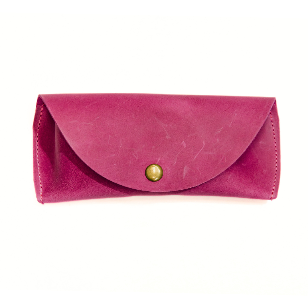Raspberry pink leather sunglasses case with a gold magnetic clasp, displayed on a white background