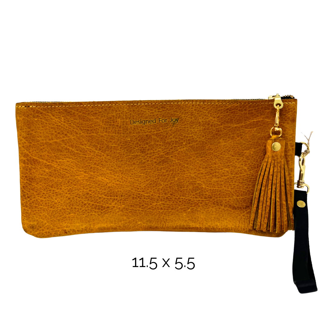 Gold-brown wristlet purse with a tassel on the zipper and a strap, on a white background