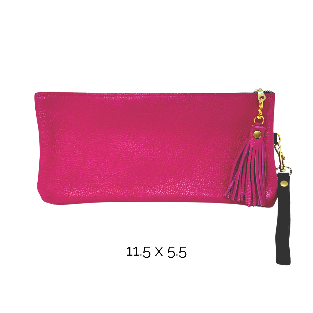 Pink wristlet purse with a tassel on the zipper and a strap, on a white background