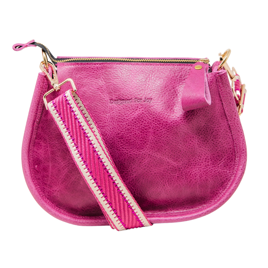 Pink pebbled leather crossbody handbag with a smooth, chunky zipper and a crossbody strap