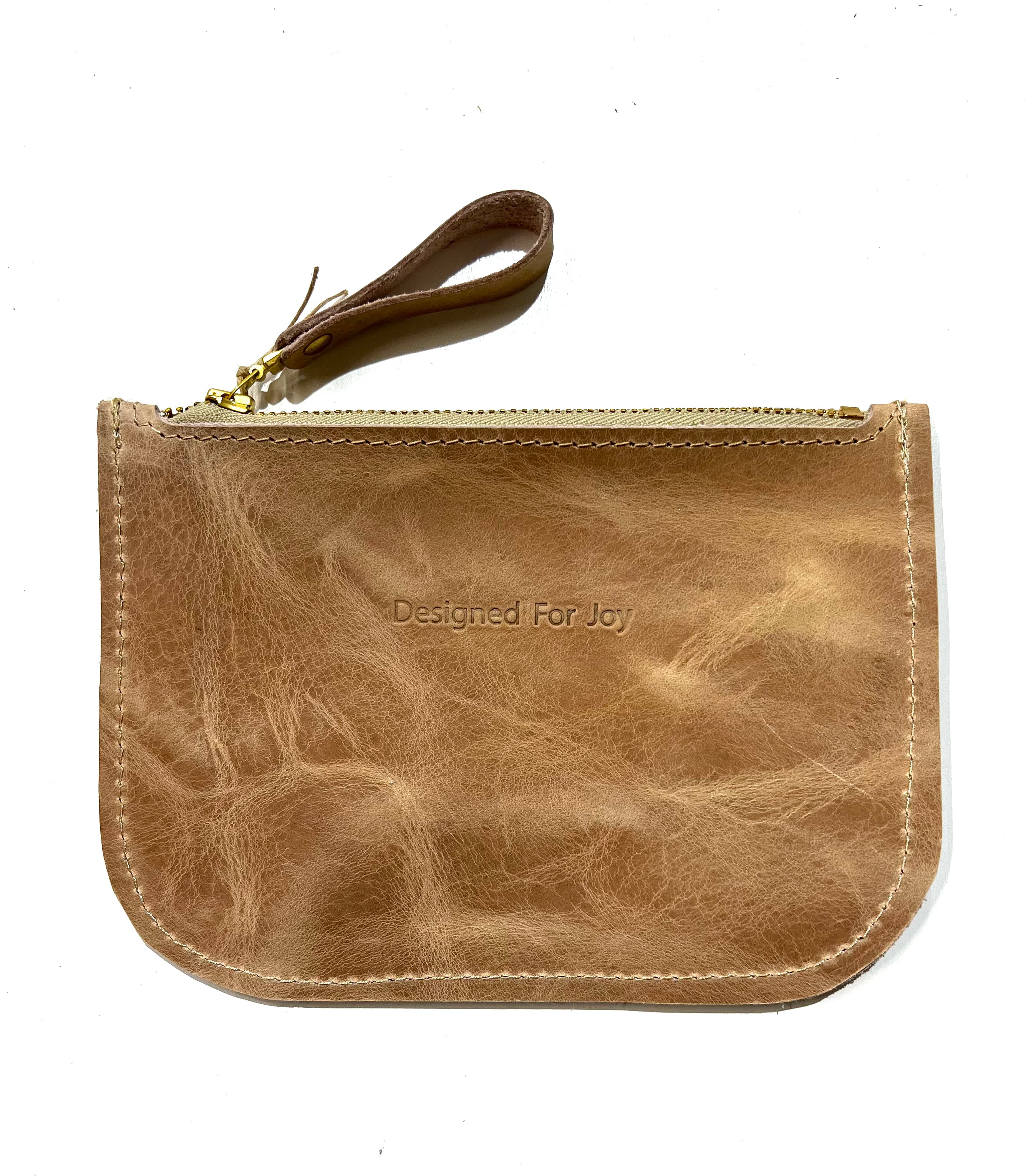 Tan leather slim zipper coin purse, displayed on a white background