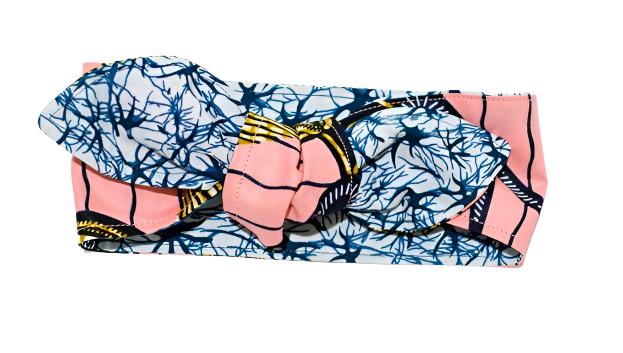 Reversible head wrap with a gold and pink pattern on one side and a blue pattern on the other, displayed on a white background