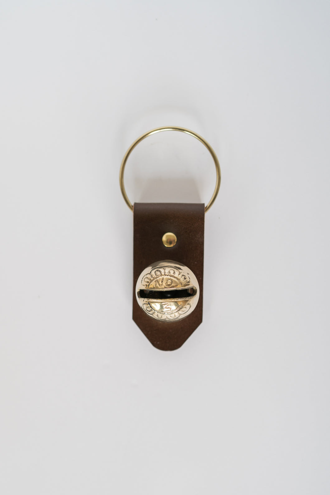 Door hanger with single bell on brown leather