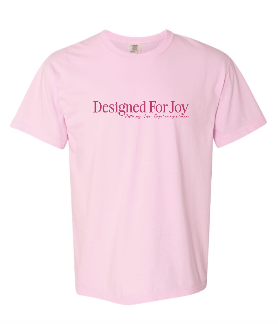 Light pink t-shirt with 'Designed For Joy Restoring Hope. Empowering Women.' text on a white background